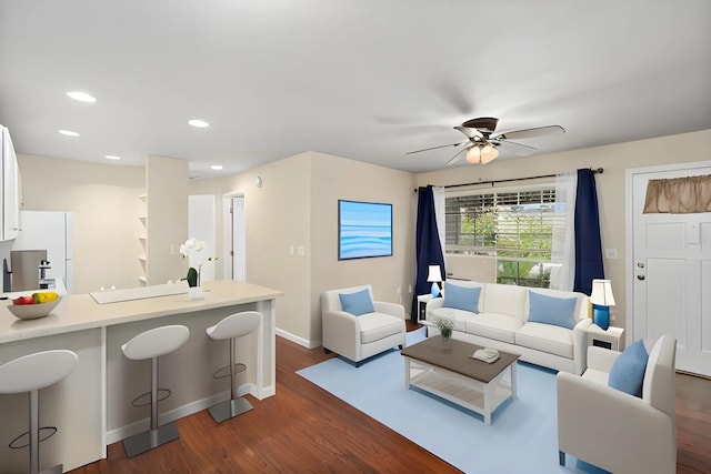 living area with baseboards, ceiling fan, dark wood finished floors, and recessed lighting