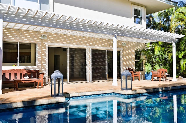 view of swimming pool with a patio and a pergola