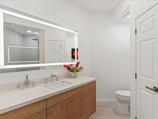 bathroom with vanity, walk in shower, tile patterned floors, and toilet