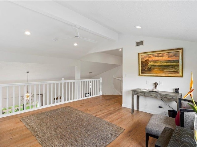 interior space with hardwood / wood-style floors, vaulted ceiling with beams, and ceiling fan