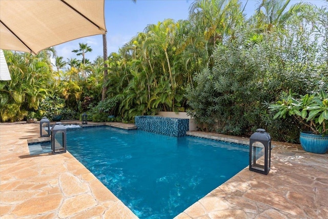 view of swimming pool with a patio area and pool water feature