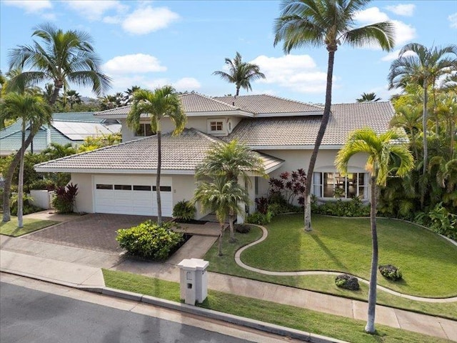 view of front of home featuring a garage and a front yard