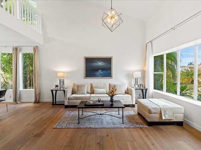 living room featuring hardwood / wood-style floors and a towering ceiling