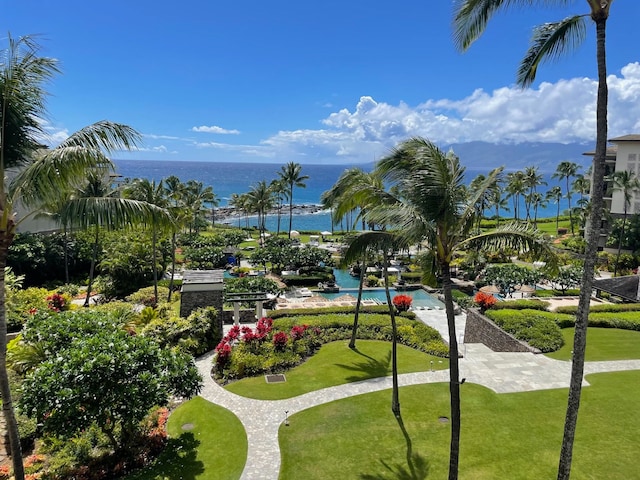 view of property's community featuring a water view and a yard