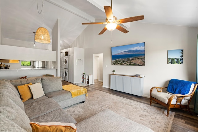 15 Kulanihakoi St Unit 9F, Kihei, HI 96753 - living room with stacked washing machine and dryer, high vaulted ceiling, beam ceiling, wood finished floors, and ceiling fan