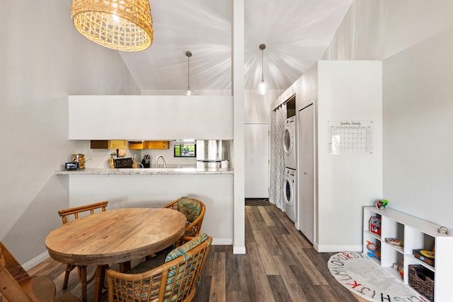 15 Kulanihakoi St Unit 9F, Kihei, HI 96753 - dining space with stacked washer / drying machine, dark wood-type flooring, and baseboards