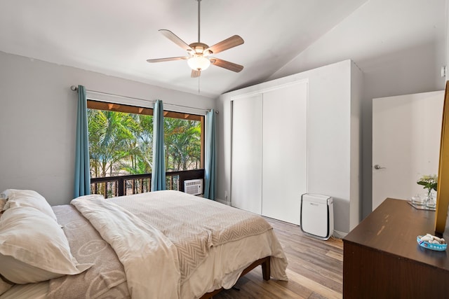 15 Kulanihakoi St Unit 9F, Kihei, HI 96753 - bedroom with a closet, wood finished floors, vaulted ceiling, ceiling fan, and cooling unit