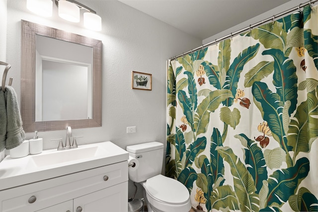 15 Kulanihakoi St Unit 9F, Kihei, HI 96753 - bathroom with vanity, toilet, a textured wall, and curtained shower