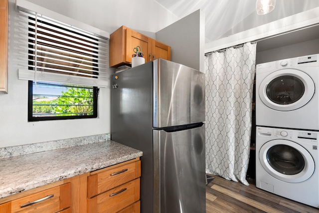 15 Kulanihakoi St Unit 9F, Kihei, HI 96753 - laundry area featuring estacked washer and dryer and dark wood-type flooring