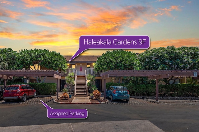 15 Kulanihakoi St Unit 9F, Kihei, HI 96753 - view of building exterior featuring covered and uncovered parking and stairway