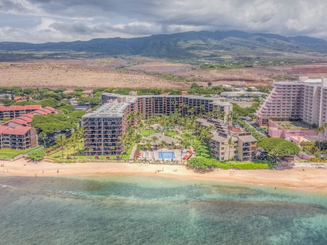 drone / aerial view featuring a beach view and a mountain view