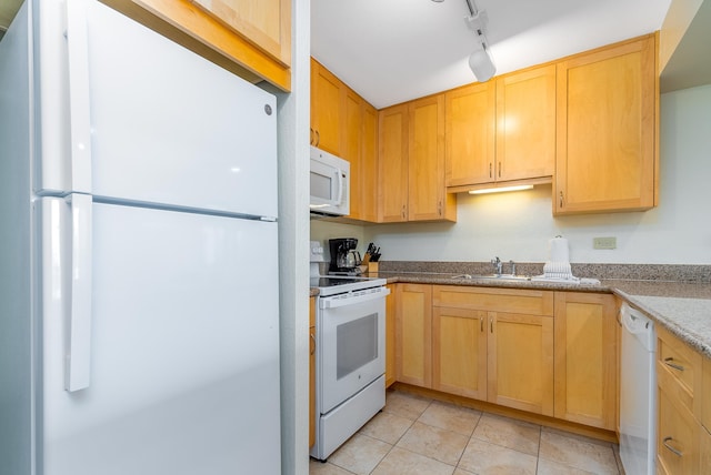 kitchen featuring white appliances, sink, light tile floors, track lighting, and light stone countertops