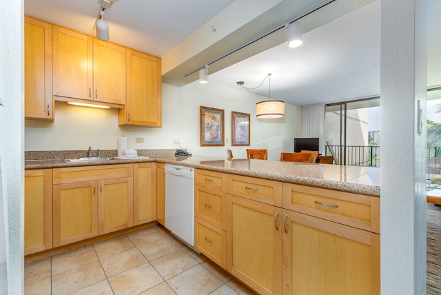 kitchen with white dishwasher, hanging light fixtures, rail lighting, and light stone counters