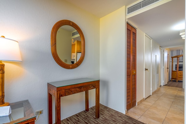 corridor featuring light tile flooring