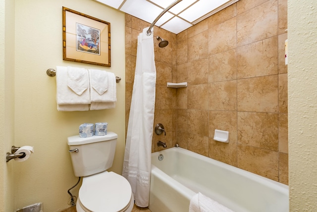 bathroom with shower / bath combination with curtain and toilet