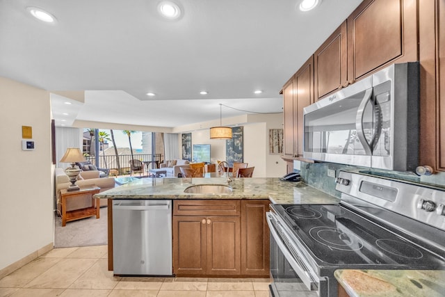 3445 Lower Honoapiilani Rd Unit 311, Lahaina, HI 96761 - kitchen with stainless steel appliances, a peninsula, light stone countertops, open floor plan, and a sink