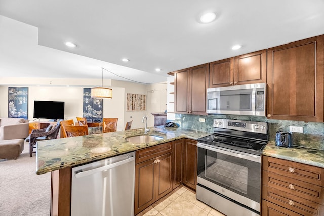 3445 Lower Honoapiilani Rd Unit 311, Lahaina, HI 96761 - kitchen with appliances with stainless steel finishes, a sink, a peninsula, open floor plan, and tasteful backsplash
