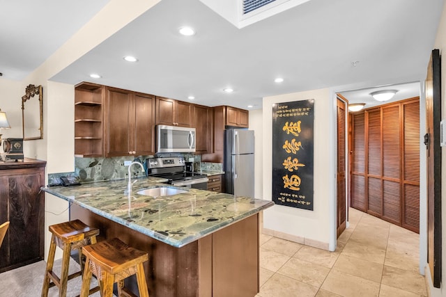 3445 Lower Honoapiilani Rd Unit 311, Lahaina, HI 96761 - kitchen with appliances with stainless steel finishes, light stone countertops, a sink, open shelves, and a peninsula