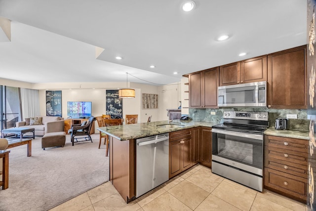 3445 Lower Honoapiilani Rd Unit 311, Lahaina, HI 96761 - kitchen featuring appliances with stainless steel finishes, open floor plan, a peninsula, light carpet, and light stone counters