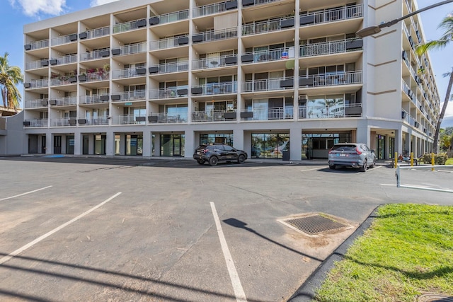 view of building exterior featuring uncovered parking