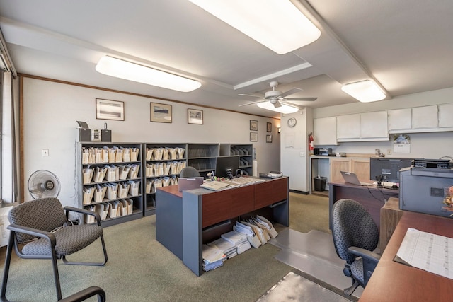 office space featuring light colored carpet, ceiling fan, and crown molding