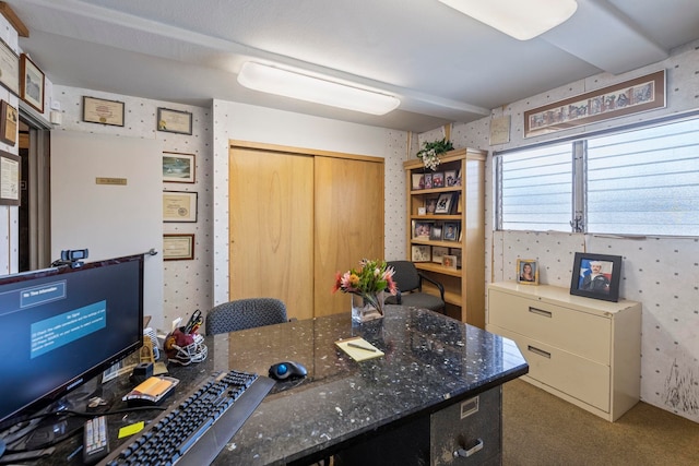 carpeted office space featuring wallpapered walls