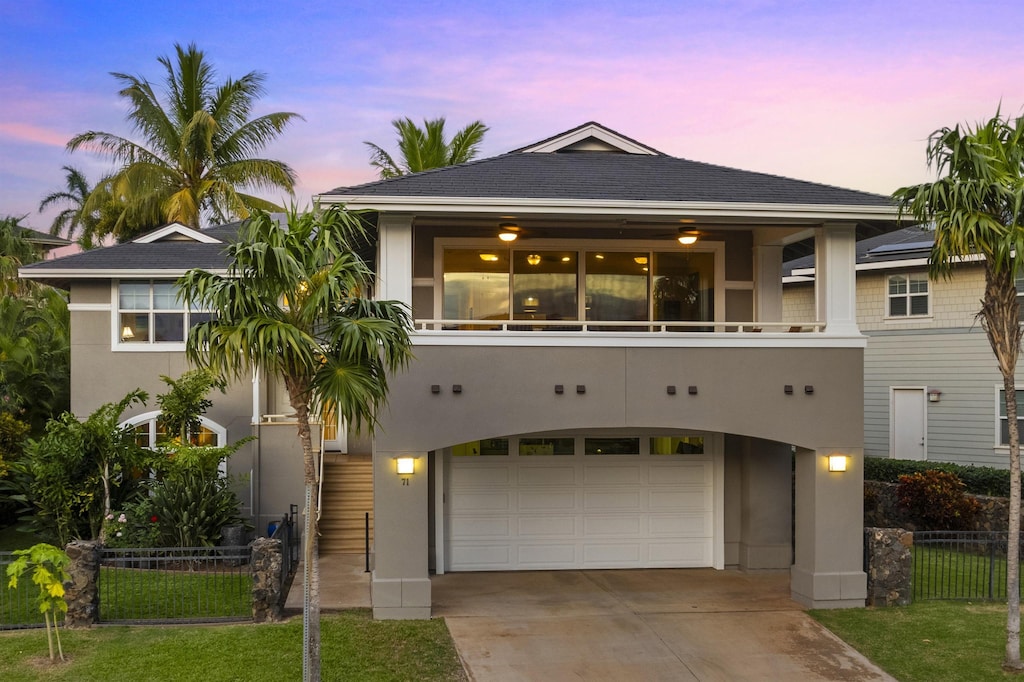 view of front of home featuring a garage and a balcony