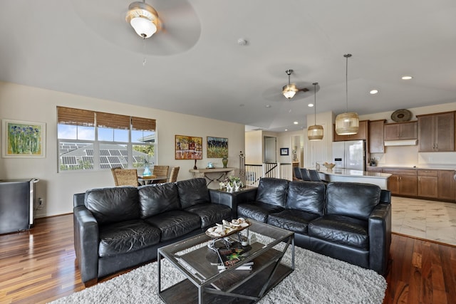 living room featuring dark hardwood / wood-style flooring and ceiling fan