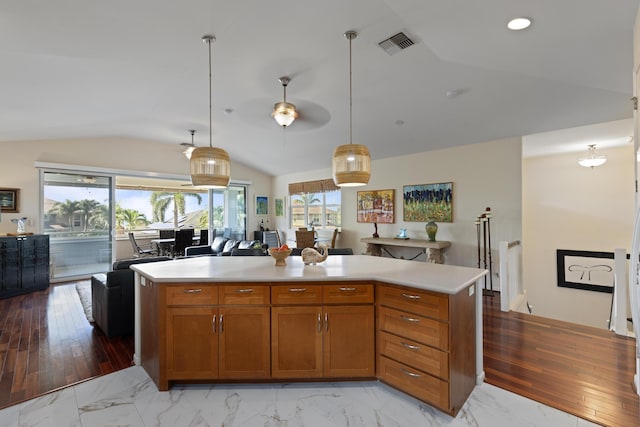 kitchen featuring lofted ceiling, hanging light fixtures, plenty of natural light, and a center island