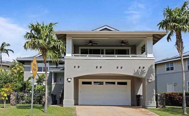 view of front of home with a garage, a balcony, ceiling fan, and a front lawn