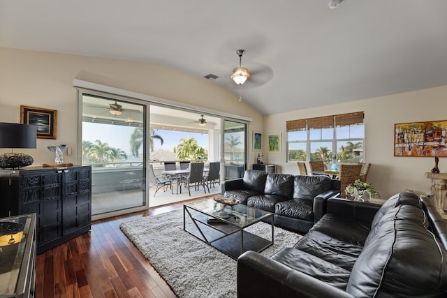 living room featuring vaulted ceiling, a wealth of natural light, ceiling fan, and dark hardwood / wood-style flooring