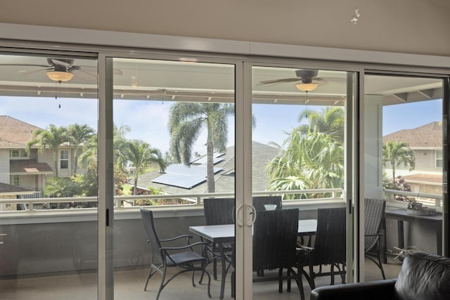 sunroom / solarium with ceiling fan and a mountain view