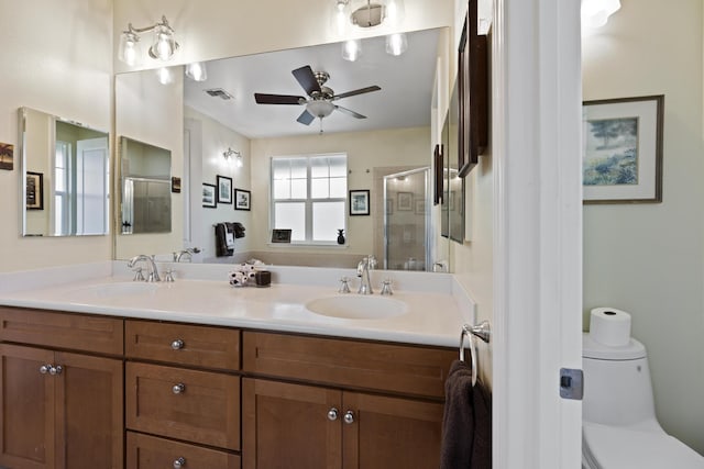 bathroom featuring vanity, ceiling fan, toilet, and walk in shower