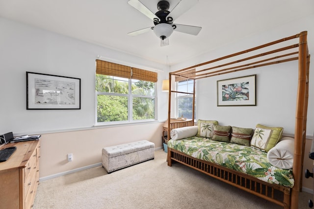 bedroom with ceiling fan and light colored carpet