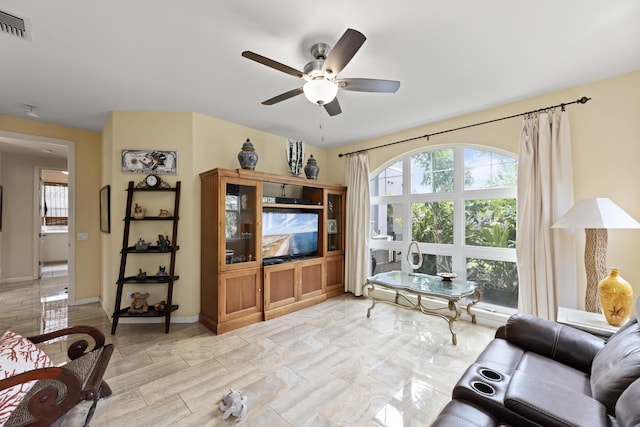 living room with ceiling fan and a healthy amount of sunlight