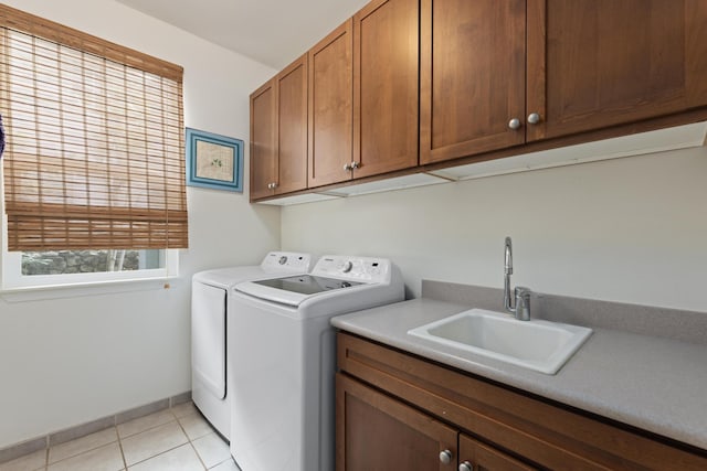 washroom with cabinets, independent washer and dryer, sink, and light tile patterned floors