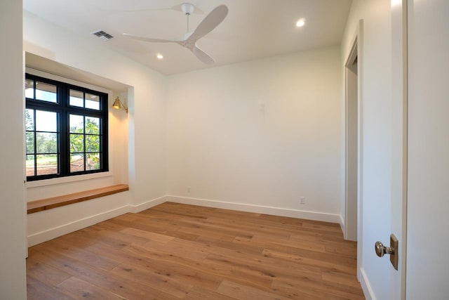 spare room featuring light wood-style flooring, recessed lighting, visible vents, and baseboards