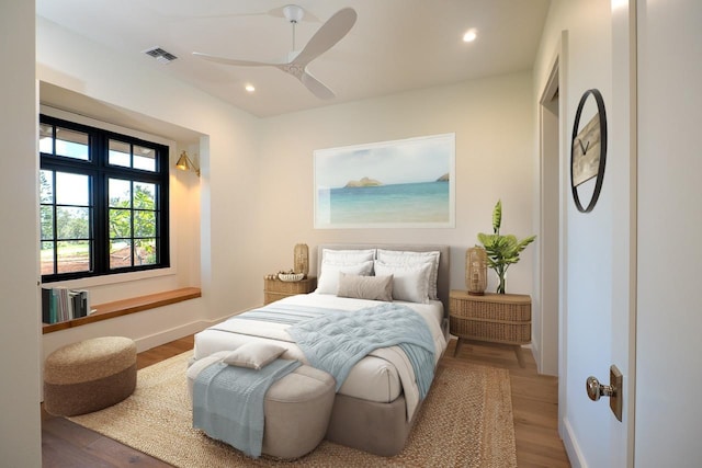 bedroom with baseboards, visible vents, wood finished floors, and recessed lighting