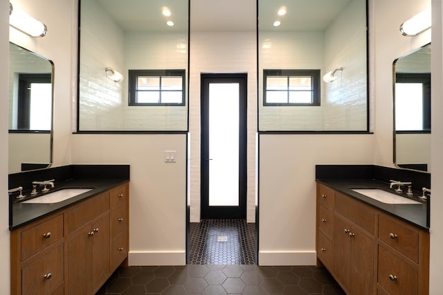 full bath featuring a wealth of natural light, a walk in shower, and a sink