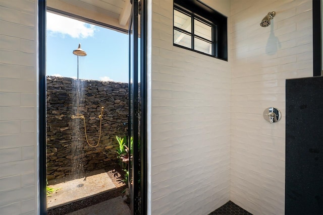 full bath featuring a tile shower