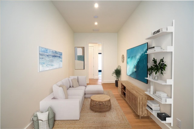 living area featuring visible vents, recessed lighting, light wood-style flooring, and baseboards