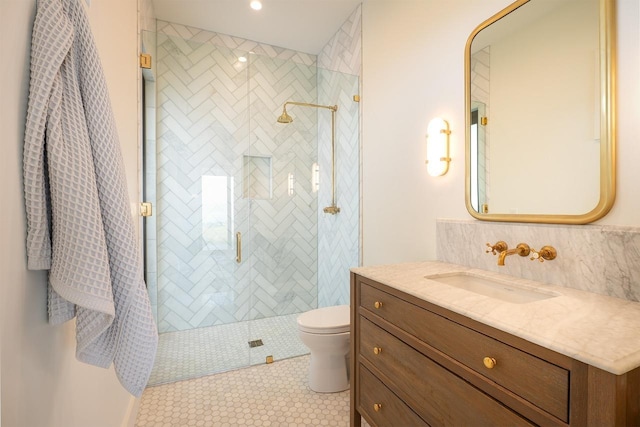 bathroom with toilet, a shower stall, tile patterned flooring, and vanity