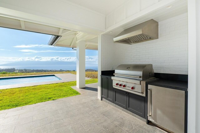 view of patio with an outdoor pool, a grill, and an outdoor kitchen