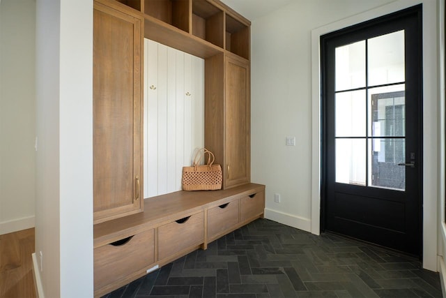 mudroom featuring a healthy amount of sunlight and baseboards