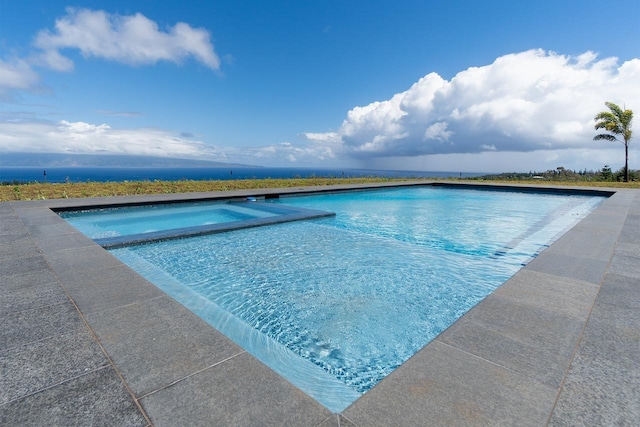 view of swimming pool with a pool with connected hot tub