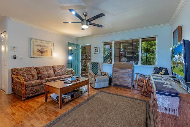 living room featuring crown molding, wood-type flooring, and ceiling fan