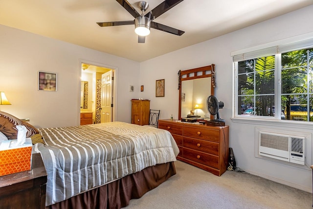 carpeted bedroom with connected bathroom, ceiling fan, and a wall mounted air conditioner