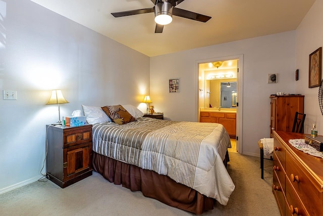 bedroom featuring ceiling fan, light carpet, and ensuite bathroom