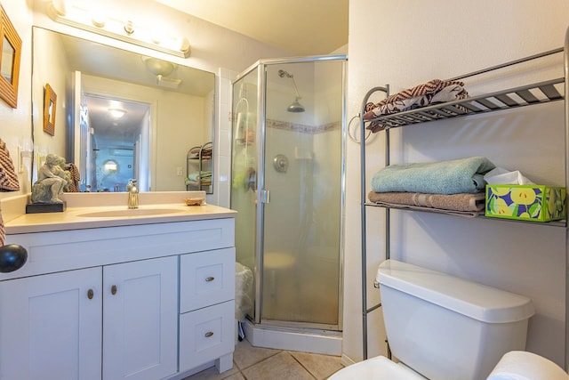 bathroom featuring tile patterned floors, walk in shower, toilet, and vanity