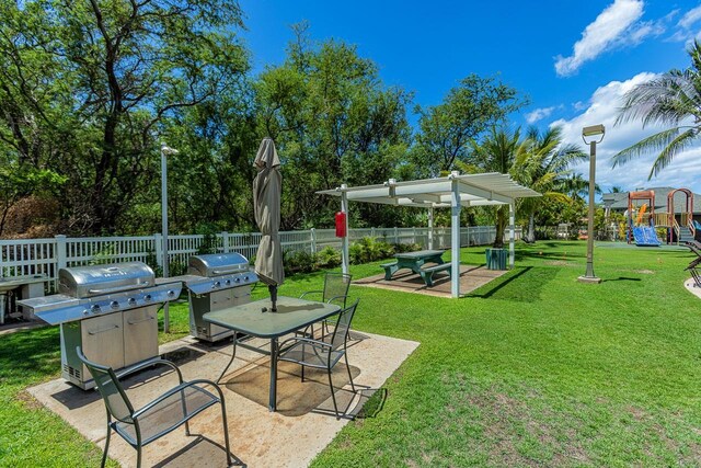 view of yard featuring a pergola, a patio, and a playground